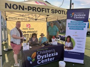 Madison Children's Dyslexia Center personnel staff an exhibit table at Warner Park in Madison, WI.